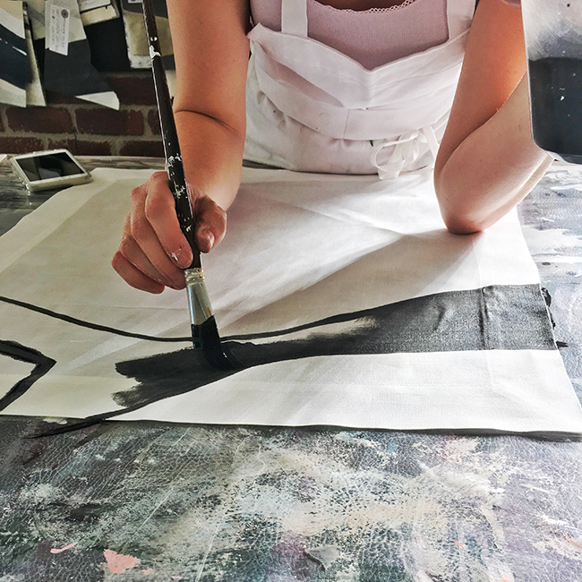 Porter Teleo artist hand painting a napkin