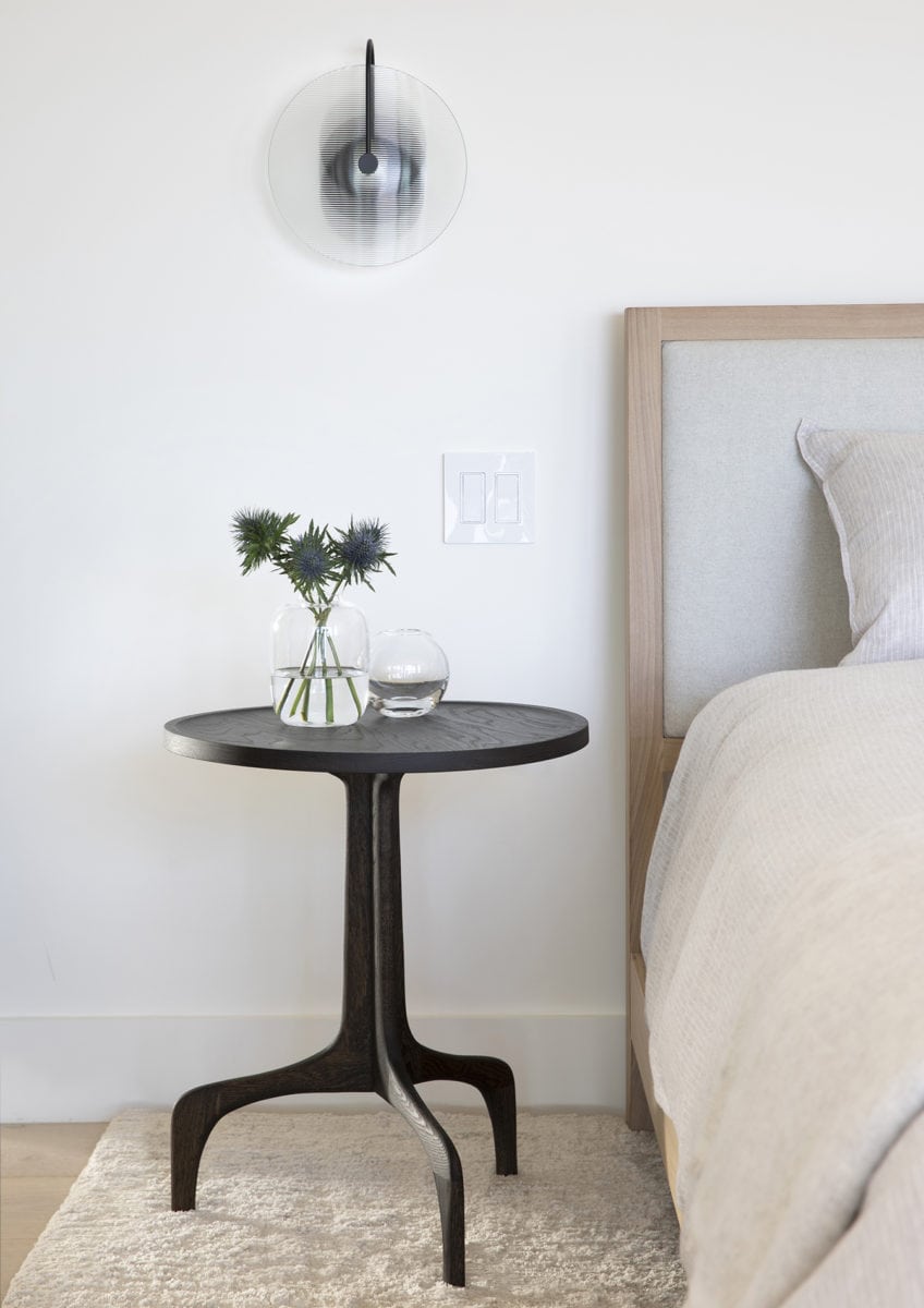 Sculptural bedside table and modern sconce in home designed by Bay Area interior designer Niche Interiors