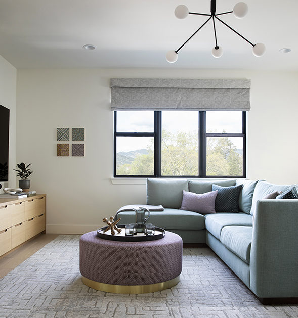Family-friendly media room with aqua sectional sofa designed by interior designer napa 