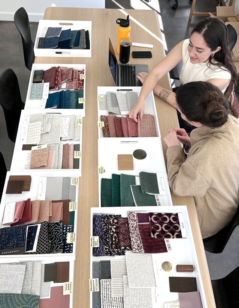 Top San Francisco interior design firm Niche Interiors reviewing fabrics and finishes for a homeowner meeting